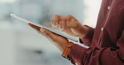 A person uses a tablet, highlighting the potential for developing various types of mobile apps.